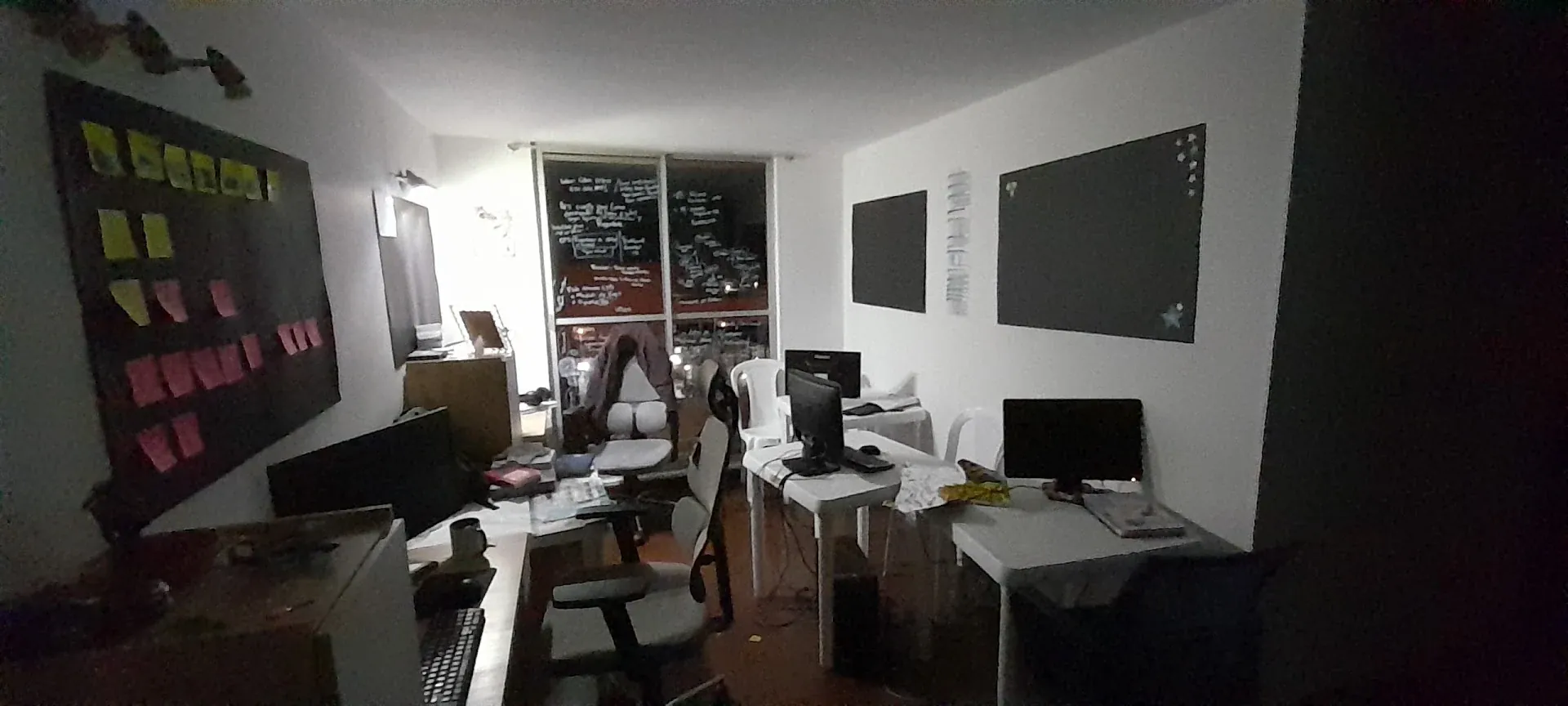 Antigua oficina de Geus ISP con tableros de notas, escritorios y equipos de trabajo.